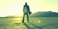 a man standing in the middle of a desert