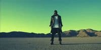 a man standing in the middle of a desert