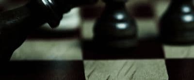 a close up of a chess board with a pawn