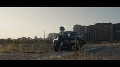 a man standing next to a truck in a field
