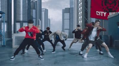 a group of young men dancing in a city