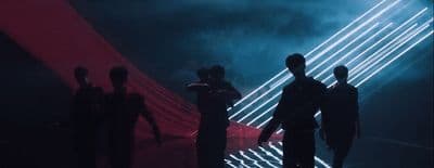 a group of people that are standing in the dark