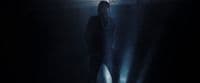 a man standing in a dark room with a flashlight
