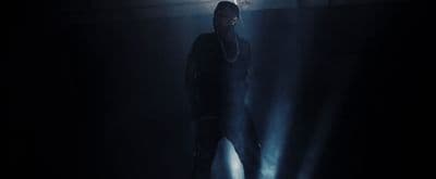 a man standing in a dark room with a flashlight