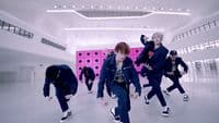 a group of young men dancing in a room
