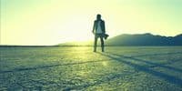 a man standing in the middle of a desert