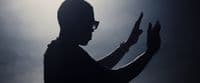 a silhouette of a man holding a cell phone