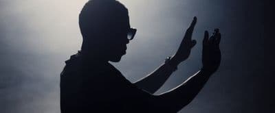a silhouette of a man holding a cell phone