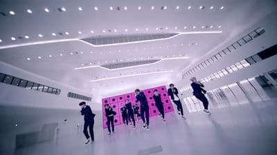 a group of people standing in a large room