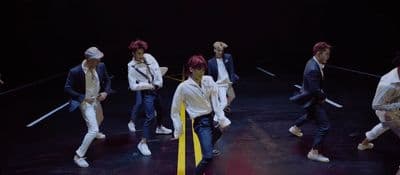 a group of young men standing on top of a stage