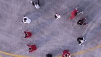 a group of people standing on top of a parking lot