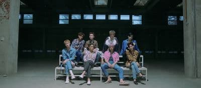 a group of people sitting on top of a white bench