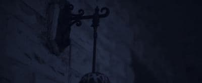 a street light on a brick wall in the dark