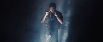 a male in a black shirt and some smoke
