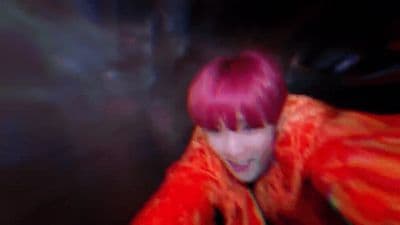 a person with pink hair and a red jacket