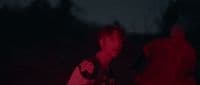 a man standing in the dark with a frisbee in his hand