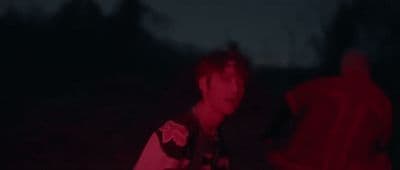 a man standing in the dark with a frisbee in his hand
