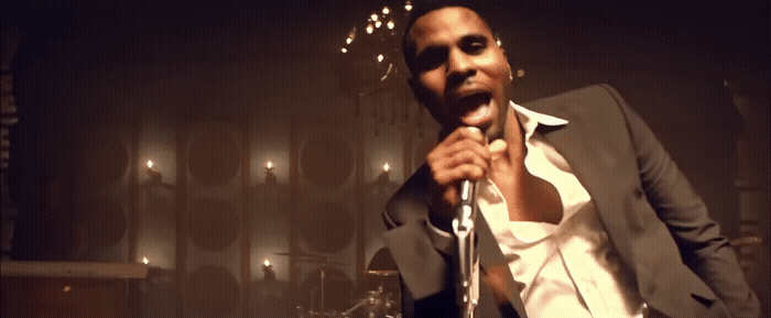 a man in a suit holding a microphone