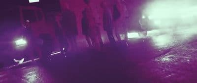 a group of people standing next to each other on a street