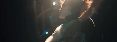 a person standing in a dark room with a light shining on them