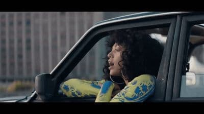 a woman sitting in the passenger seat of a car