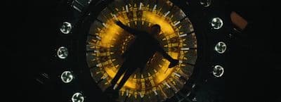 a clock with a person standing inside of it