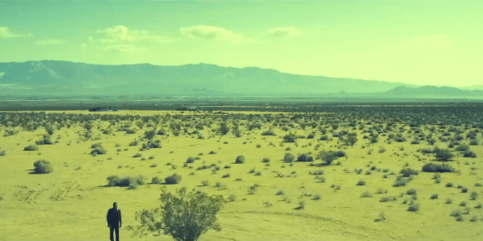 a man standing in the middle of a desert