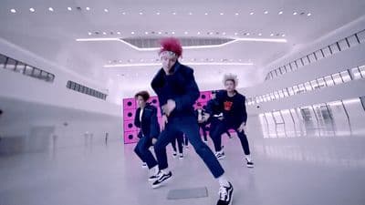 a group of people are dancing in a room