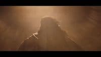 a blurry image of a man in a dark room