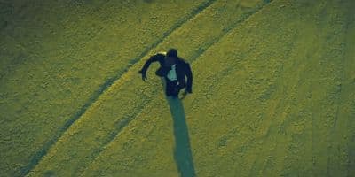 a man standing in the middle of a field