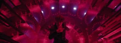 a woman standing in a room with red lights