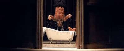a man falling off of a bathtub in a bathroom