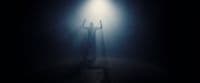 a person standing under a light in the dark