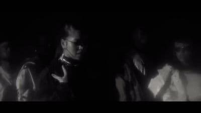 a group of people standing in a dark room