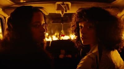a couple of women sitting in the back of a car