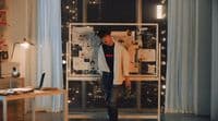 a man standing in front of a window in a room