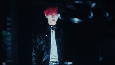 a man with red hair wearing a black leather jacket