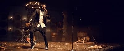 a man standing on a stage holding a microphone