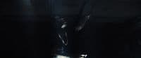 a person standing in a dark room with a light on