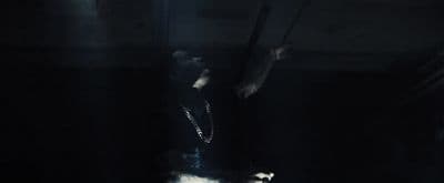 a person standing in a dark room with a light on