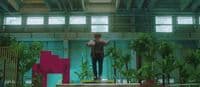 a man standing on a platform in a building