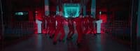 a group of people dressed in red dancing in a hallway