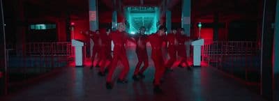 a group of people dressed in red dancing in a hallway