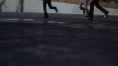 a couple of people that are walking down a street