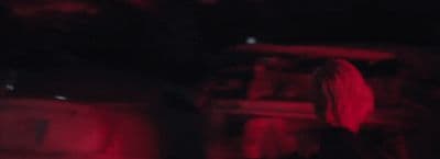 a blurry image of a person standing in the dark