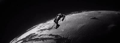 a black and white photo of a person on a surfboard