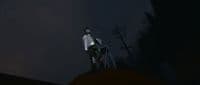 a man standing on top of a hill at night
