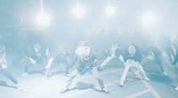 a group of people dancing in a foggy area