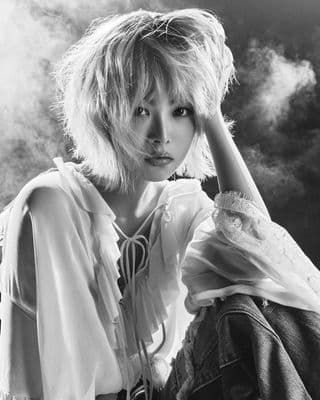 a black and white photo of a woman with blonde hair