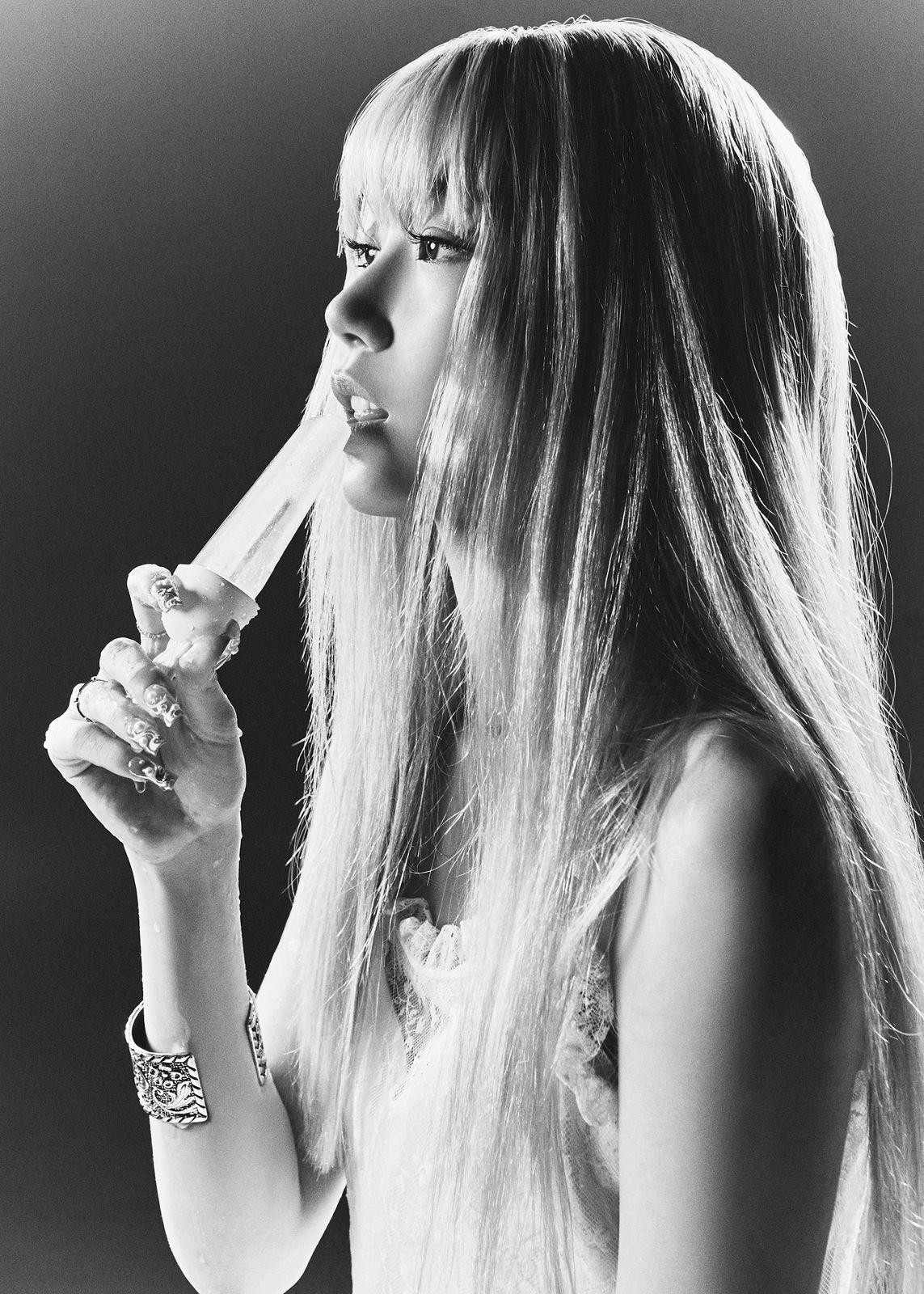 a black and white photo of a woman brushing her teeth